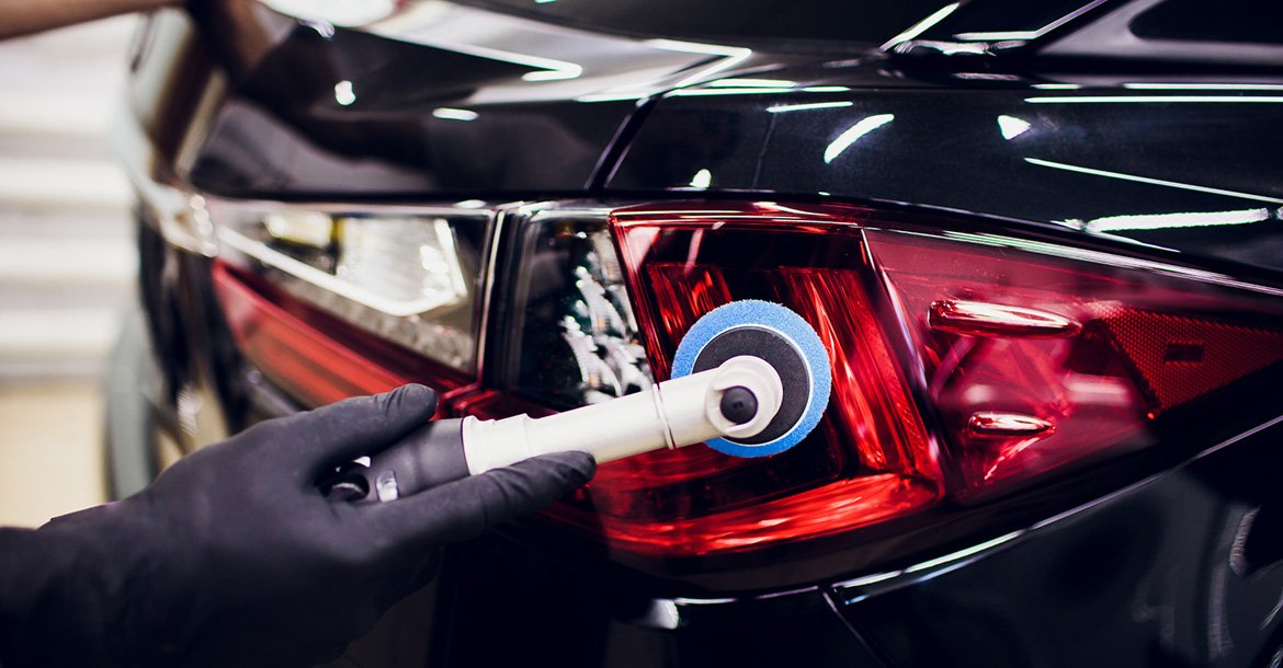 Car polish wax worker hands holding polisher