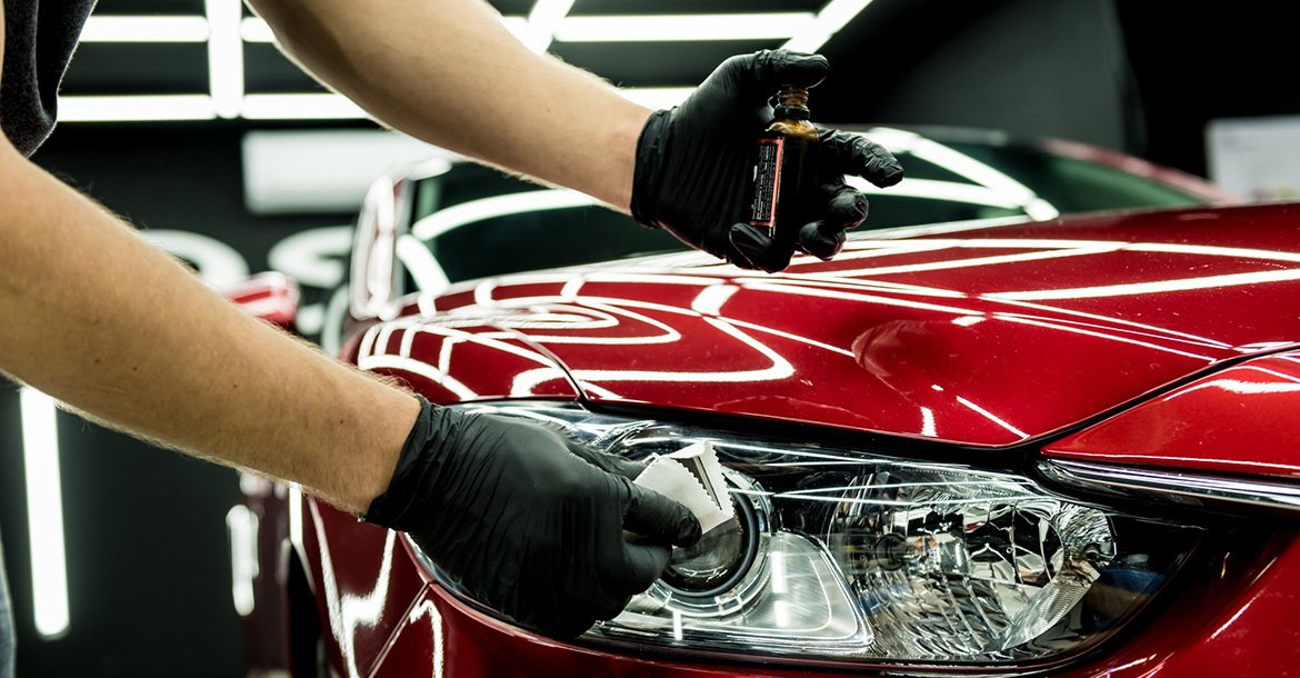Car service worker applying nano coating